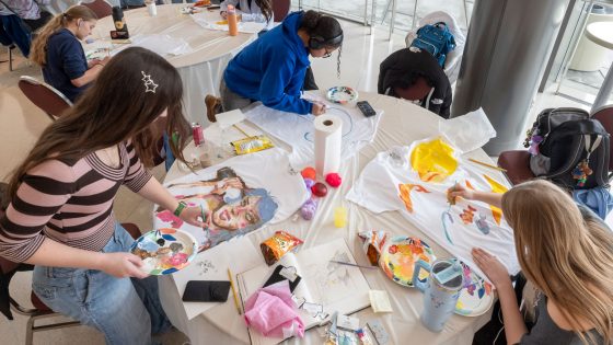 Sophia Fernandez paints a T-shirt during the Des Lee festival