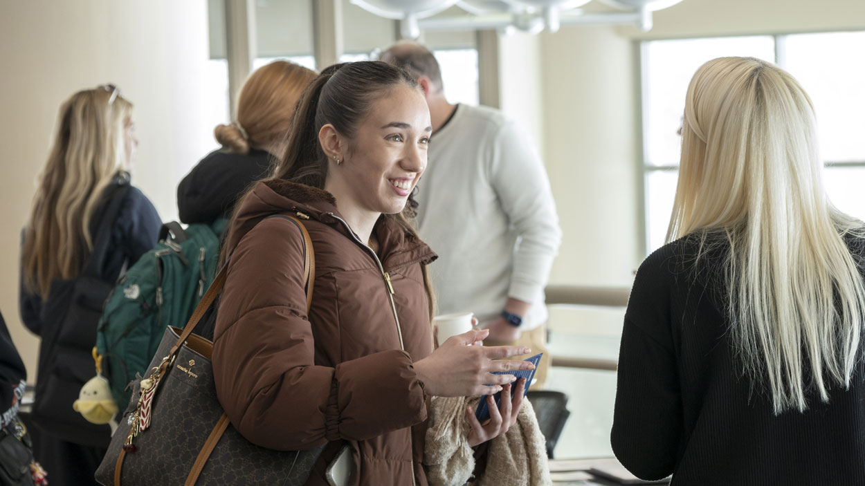 Freshman computer science major Viktoria Dimitrova talks to Teaching Professor Jennifer Siciliani about an upcoming study abroad trip she's leading to Greece during the annual Study Abroad Fair.