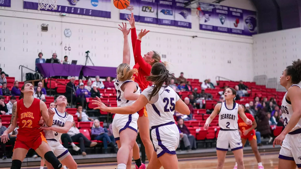 Morgan Ramthun shoots while being guarded by two McKendree defenders