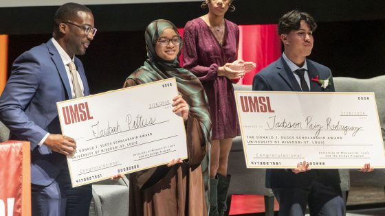 Vice Chancellor Reggie Hill presents full-tuition UMSL Donald J. Suggs Scholarships to Bridge Program seniors Taubah Pettus and Jackson Paiz Rodriguez.
