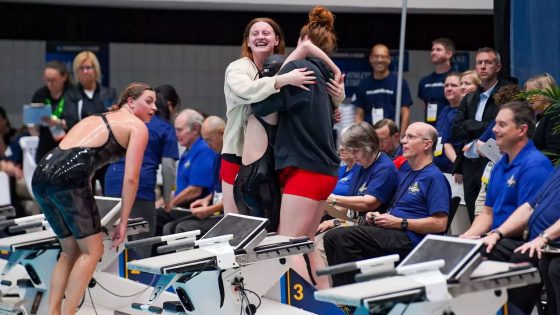 Teammates gather to celebrate with Justice Beard after she placed second in the 1,650-yard freestyle race at the 2025 NCAA Division II Swimming and Diving Championships