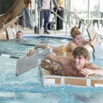 Sophomore electrical engineering major Mattia Nardi takes off in the lead in the UMSL Recreation and Wellness Center's Cardboard Boat Racing event while Chiara Alberola gives chase and Paul Williams sinks on March 12