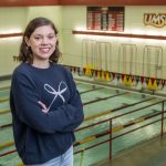 Justice Beard stands with the UMSL Swimming Pool behind her