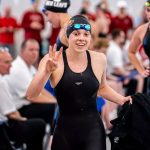 UMSL junior Justice Beard holds up three fingers are winning the women's 1,650-yard race on Saturday evening to capture her third individual title at this week's NCAA Division II Swimming and Diving Championships in Evansville, Indiana.