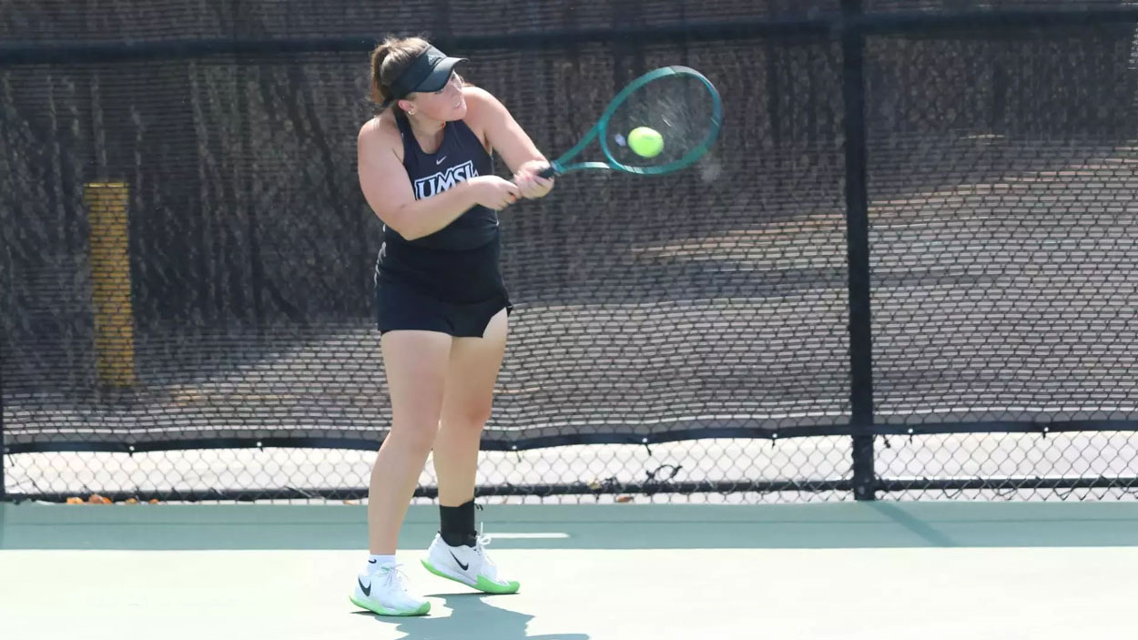 UMSL tennis player Morgan Lint hits a two-handed backhand