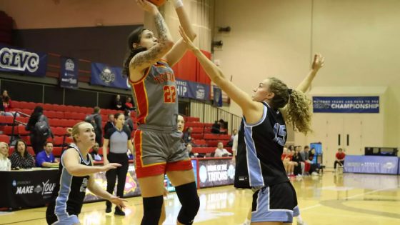 Mara Rieder shoots a baseline jump shot over an Upper Iowa defender