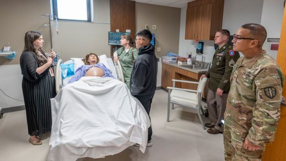 UMSL Assistant Teaching Professor Jinnie Tkach gives a tour of the College of Nursing SIM Labs to members of active and reserve components of the U.S. Army