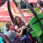 left to right, biology major, Maggie Lang, biology major Nadia Manushev, and marketing major Daira Sangurima ride the Tornado.