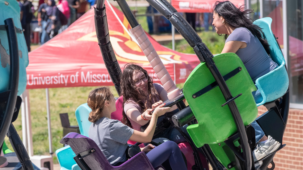 left to right, biology major, Maggie Lang, biology major Nadia Manushev, and marketing major Daira Sangurima ride the Tornado.