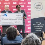 Congressman Wesley Bell presents a ceremonial check to UMSL Vice Chancellor Chris Spilling and API Innovation Center President and Chief Operating Officer Kevin Webb at a media event