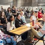 UMSL alum Matthew Lucy speaks with current students in the Pierre Laclede Honors College during a professional development reception in the Ed Collabitat on April 16