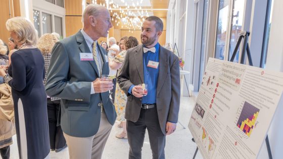 Biology doctoral student George Todd discusses his research with Robert R. Hermann Jr. during a cocktail hour at the Robert R. Hermann World Ecology Award Gala