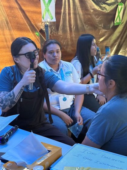 Kiley Stout examines a patient at an I Care clinic in El Salvador