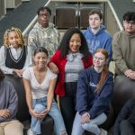 Channon Peoples surrounded by students in the Bridge Program Saturday Academy