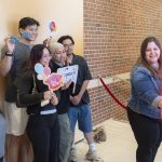 A group of graduating students stand together in the photo booth at the 2026 Triton Toast event