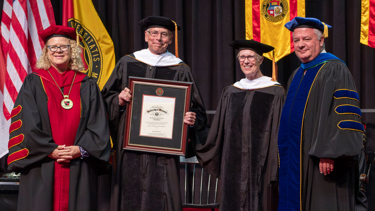 UMSL Chancellor Kristin Sobolik and Provost Steven Berberich pose with honorary degree recipients Stanley Freerks, MBA 1992 and Terry Freerks, BA 1977, MEd 1979.