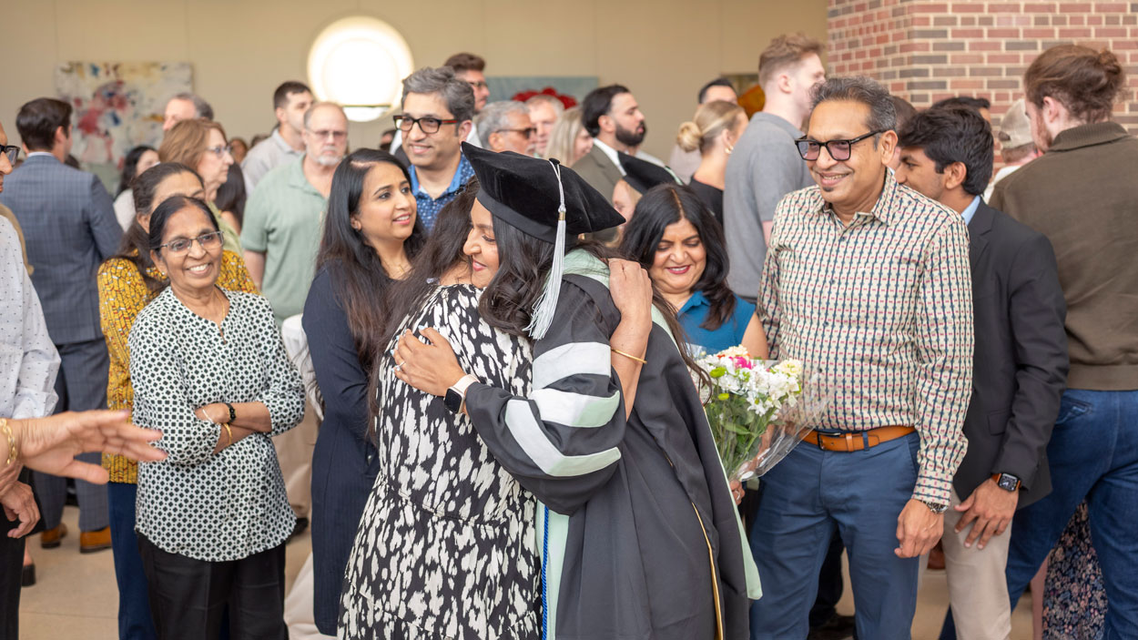 An UMSL Doctor of Optometry graduate is surrounded by family and friends after the commencement ceremony held in the Touhill Performing Arts Center on May 15.