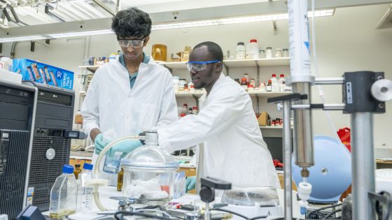 Doctoral candidate Taiwo Adeniji works in the lab with Marquette rising senior Ayush Vasireddy