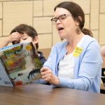 Rebecca Rogers reads to elementary school students