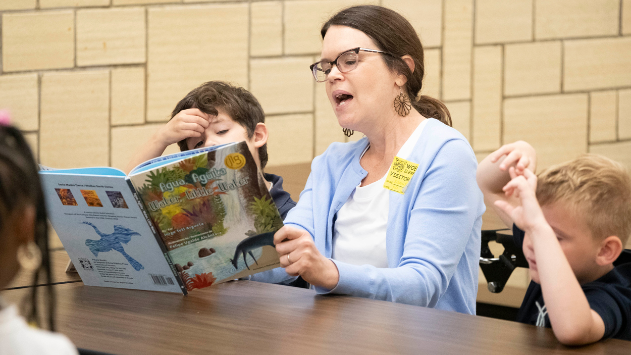 Rebecca Rogers reads to elementary school students