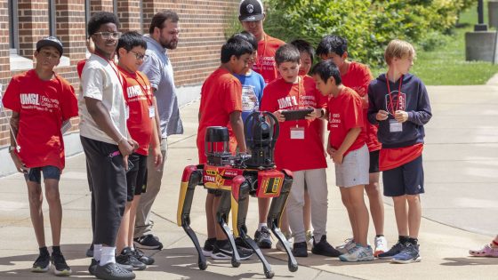 Middle school students operate Titan, UMSL's agile mobile robot dog, during a camp for middle school students on June 22-23