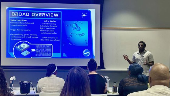 Hazelwood East graduate Simon Mwangi discusses his research in Stephen Holmes' lab during the CLIMB program's closing celebration on July 10 in Benton Hall