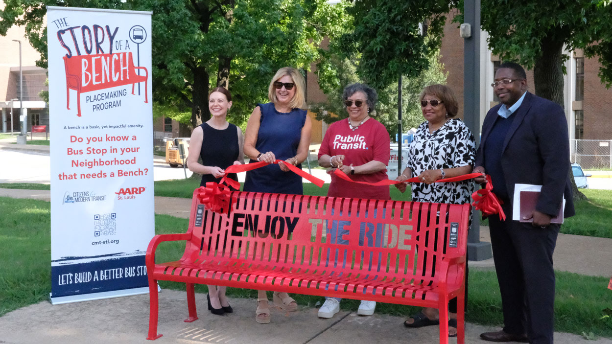 UMSL Chief of Staff Adella Jones cuts a ribbon to mark the installation of a new bus bench, courtesy of Citizens for Modern Transit's "The Story of a Bench" program. She is joined by Citizens for Modern Transit Board Chair Ellie Glenn Harmon, CMT CEO Kim Cella, St. Louis County Council Chair Rita Heard Days and Metro Transit COO Ronald Forrest