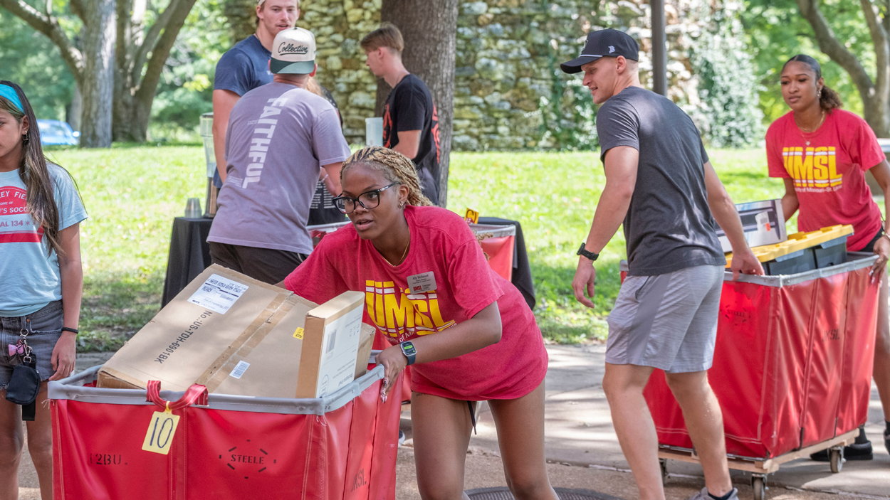 UMSL Orientation Leader Ally McIntosh helps new students move into Oak Hall. University of Missouri–St. Louis welcomed families and new students to campus during move in Day at Oak Hall. 