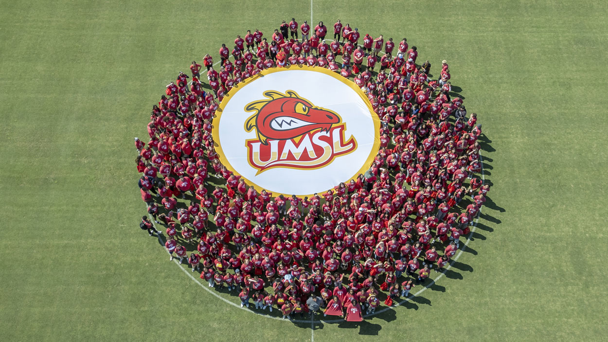 First-year students at the University of Missouri–St. Louis huddled together at the middle of the Don Dallas Soccer Field on Friday afternoon during New Student Orientation and showed off a Louie the Triton logo as UMSL photographer Derik Holtmann used a drone to capture their photo from overhead.