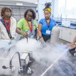 A group of eighth graders in the Bridge Program's Middle School Summer Academy made ice cream while using liquid nitrogen last month in a science class led by teacher Centennial Day (second from right) in the Science Learning Building at the University of Missouri–St. Louis.