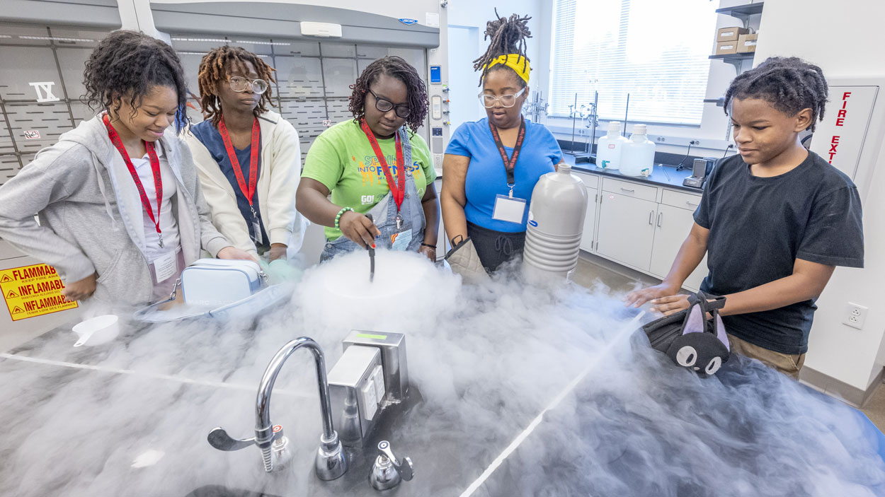 A group of eighth graders in the Bridge Program's Middle School Summer Academy made ice cream while using liquid nitrogen last month in a science class led by teacher Centennial Day (second from right) in the Science Learning Building at the University of Missouri–St. Louis.