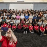 Jessica Hylton takes a selfie with UMSL's newest international students at Global Triton Welcome