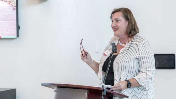 Laura Richter discusses her late father, Kirk Richter, during a dedication ceremony for the new Richter Family Welcome and Alumni Center