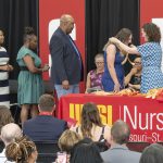 August graduates walk across the stage to receive their pins during the College of Nursing's Graduation Awards and Pinning Ceremony last Wednesday in the ED Collabitat