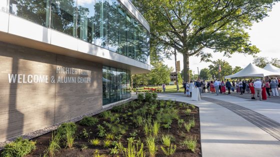 Alumni and donors gather outside the new Richter Family Welcome and Alumni Center for a dedication on Thursday evening.
