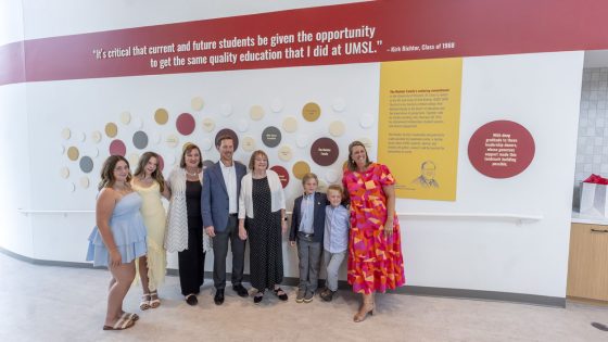 Members of the Richter family stand in front of the donor wall at the new Richter Family Welcome and Alumni Center