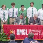 St. Mary's South Side Catholic High School President Mike England and Interim Chancellor Chris Spilling sign a memorandum of understanding between the two institutions at a ceremony Tuesday in the St. Mary's gymnasium.