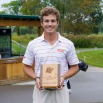 Junior golfer Campbell Cox holds the plaque he won after finishing with the best individual score at the Midwest/Central Region Preview at The Meadows at Grand Valley State
