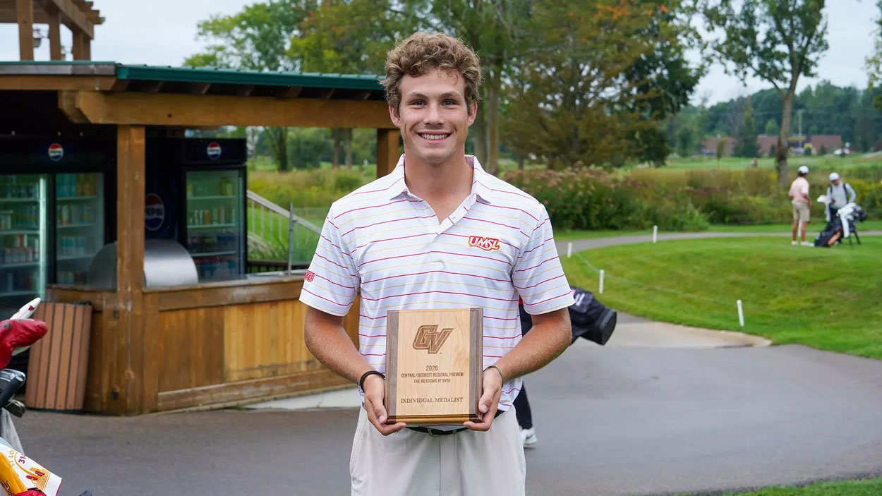 Junior golfer Campbell Cox holds the plaque he won after finishing with the best individual score at the Midwest/Central Region Preview at The Meadows at Grand Valley State