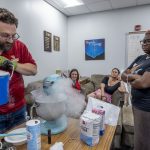 Physics and Astronomy Club President Jesse Bier uses liguid nitrogen to make ice cream for his fellow club members during an in cream social that was held Sept. 4 in Benton Hall at the University of Missouri–St. Louis.