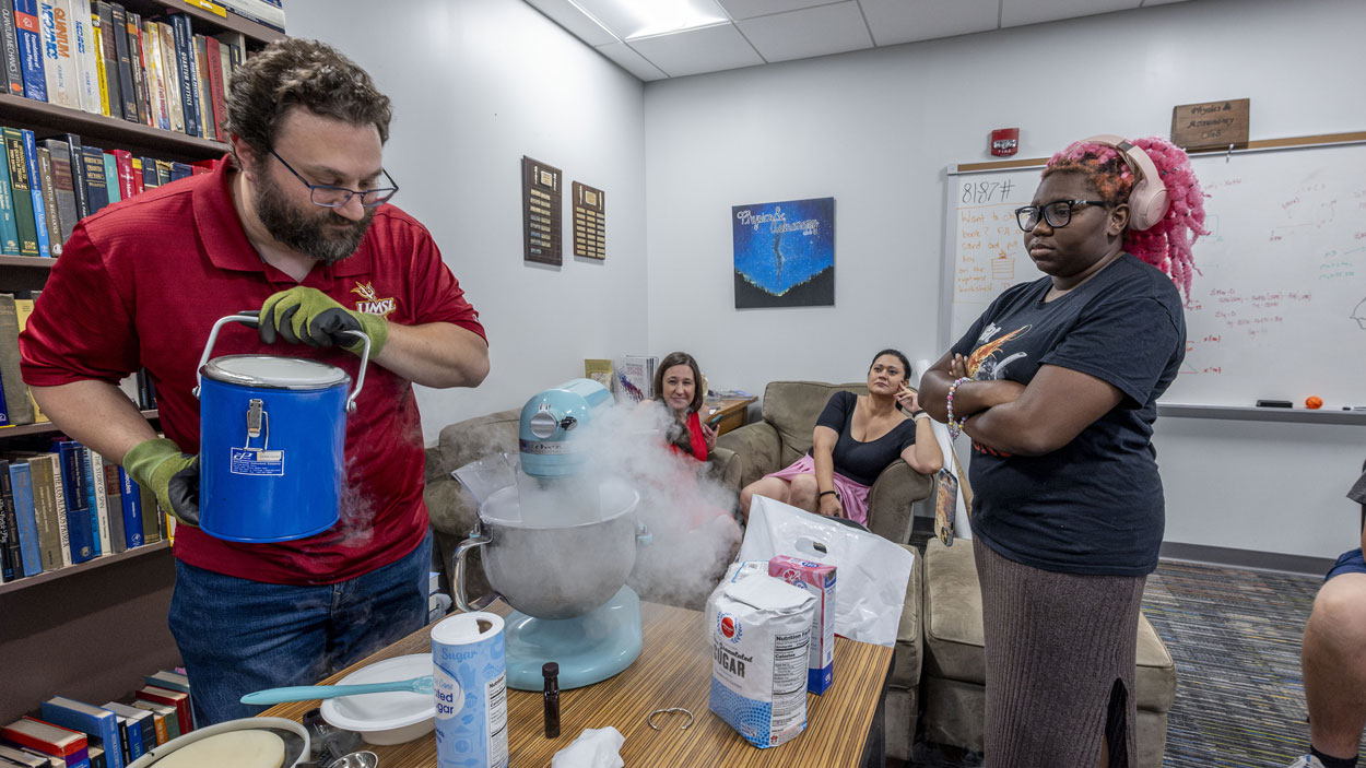 Physics and Astronomy Club President Jesse Bier uses liguid nitrogen to make ice cream for his fellow club members during an in cream social that was held Sept. 4 in Benton Hall at the University of Missouri–St. Louis.
