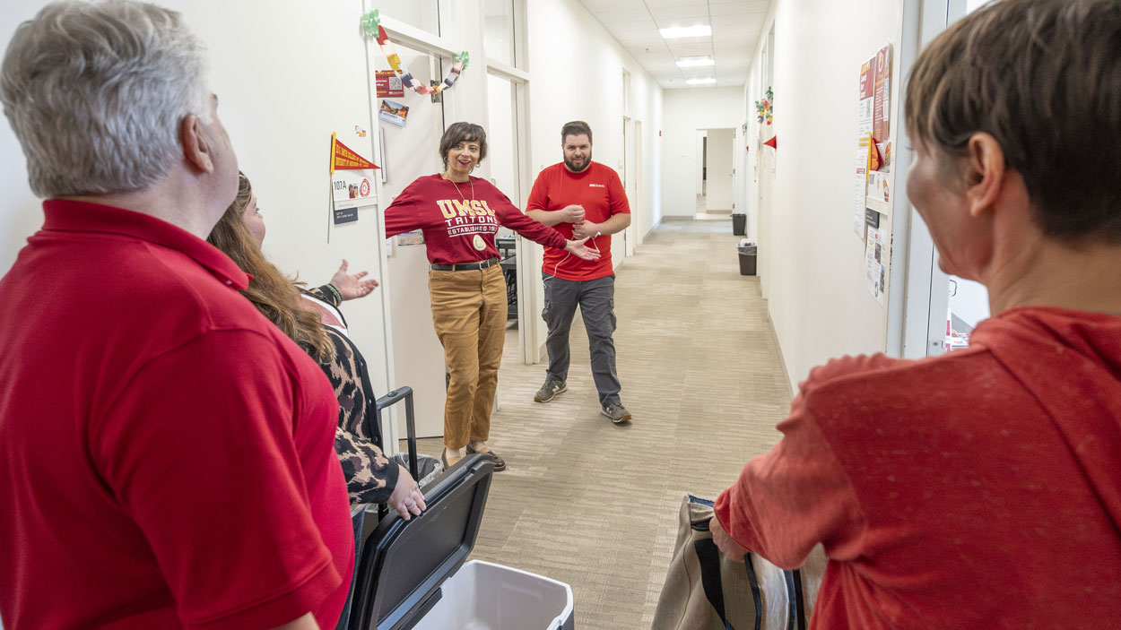 Ed G. Smith College of Business Senior Academic Advisor Antoniette Sterling and Professional Success Coordinator Tyler VonJensen come out of their offices to show off their spirit last Friday as University of Missouri–St. Louis Interim Chancellor Chris Spilling, Vice Provost for Student Affairs Jessica Long-Pease and Senior Human Resources Partner Heather Floden make the rounds through Anheuser-Busch Hall during Spirit Fri-YAY.