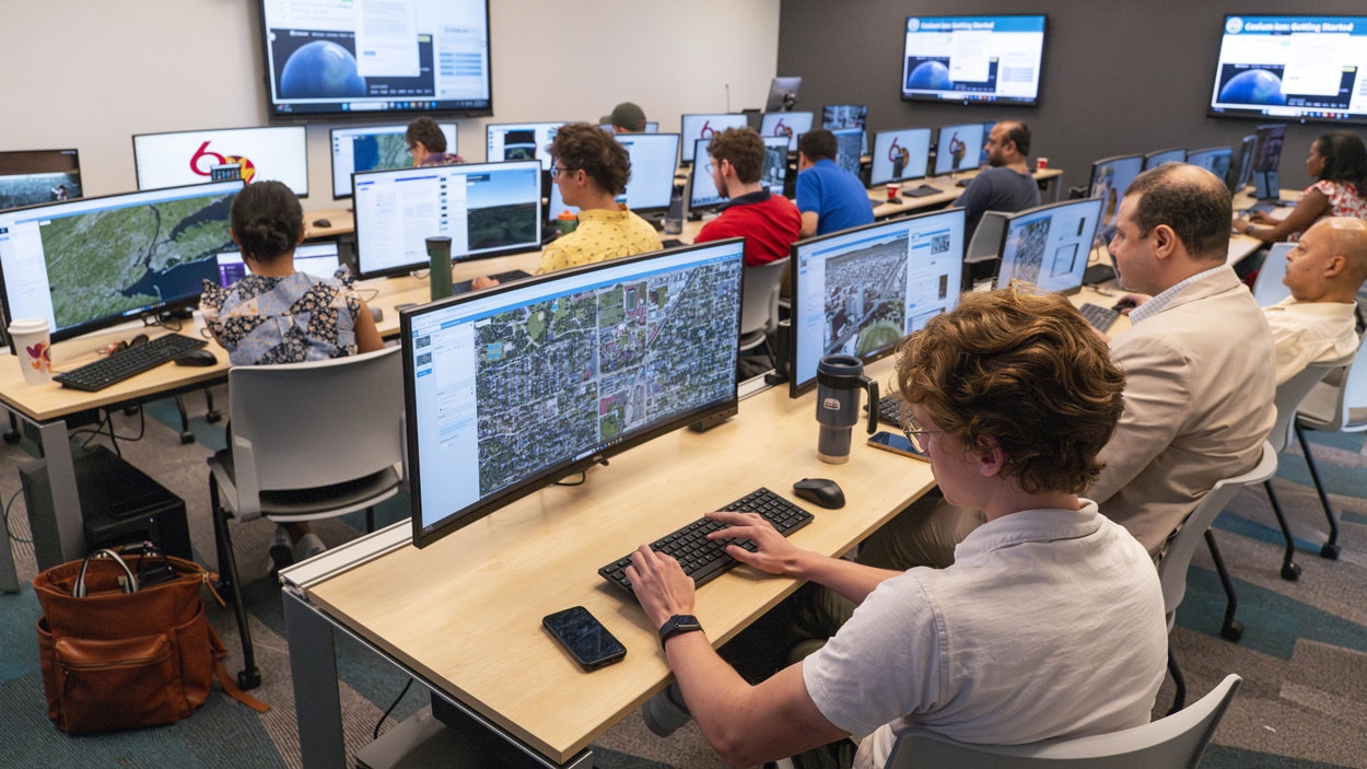 Students use mapping software during a geospatial workshop at UMSL