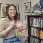 Jodi Woosley holds a copy of "Route 66: Faces and Places Along America's Most Famous Road"
