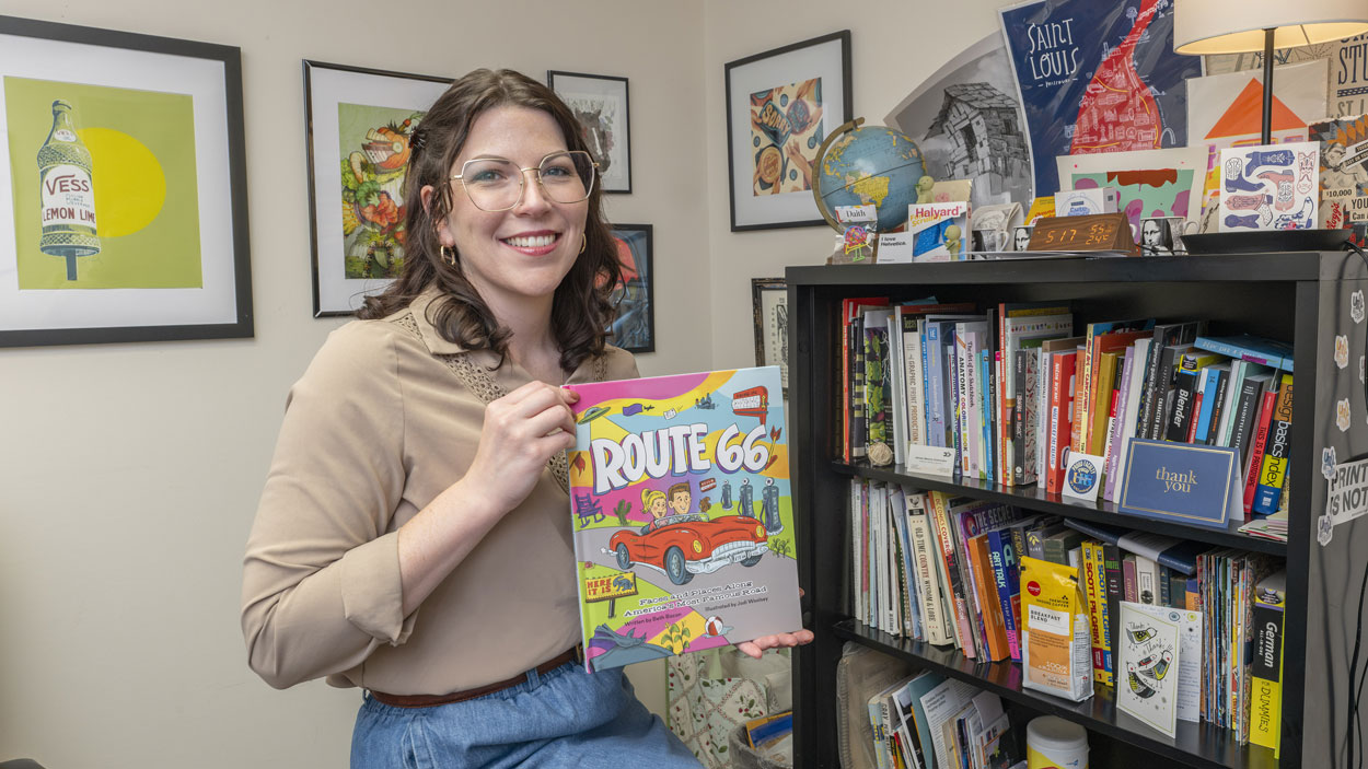 Jodi Woosley holds a copy of "Route 66: Faces and Places Along America's Most Famous Road"