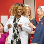 A nursing student recieves their white coat during the Lighting the Path Ceremony held in the MSC on Wedensday September 23, 2026. The ceremony presents nursing students with their white coat to symbolize their transition from the classroom to practice.