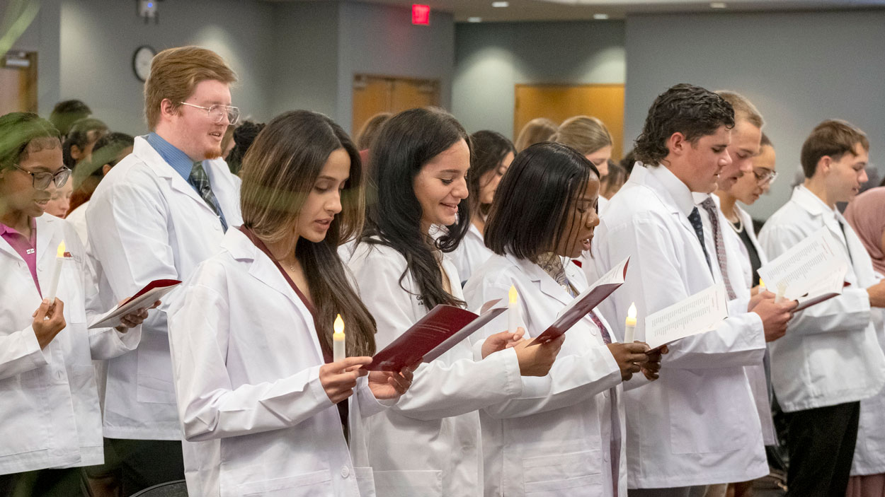 Students in the UMSL College of Nursing, recite "The Nursing Student Pledge of Commitment" during the Lighting the Path Ceremony held in the MSC on Wedensday September 23, 2026. The ceremony presents nursing students with their white coat to symbolize their transition from the classroom to practice.