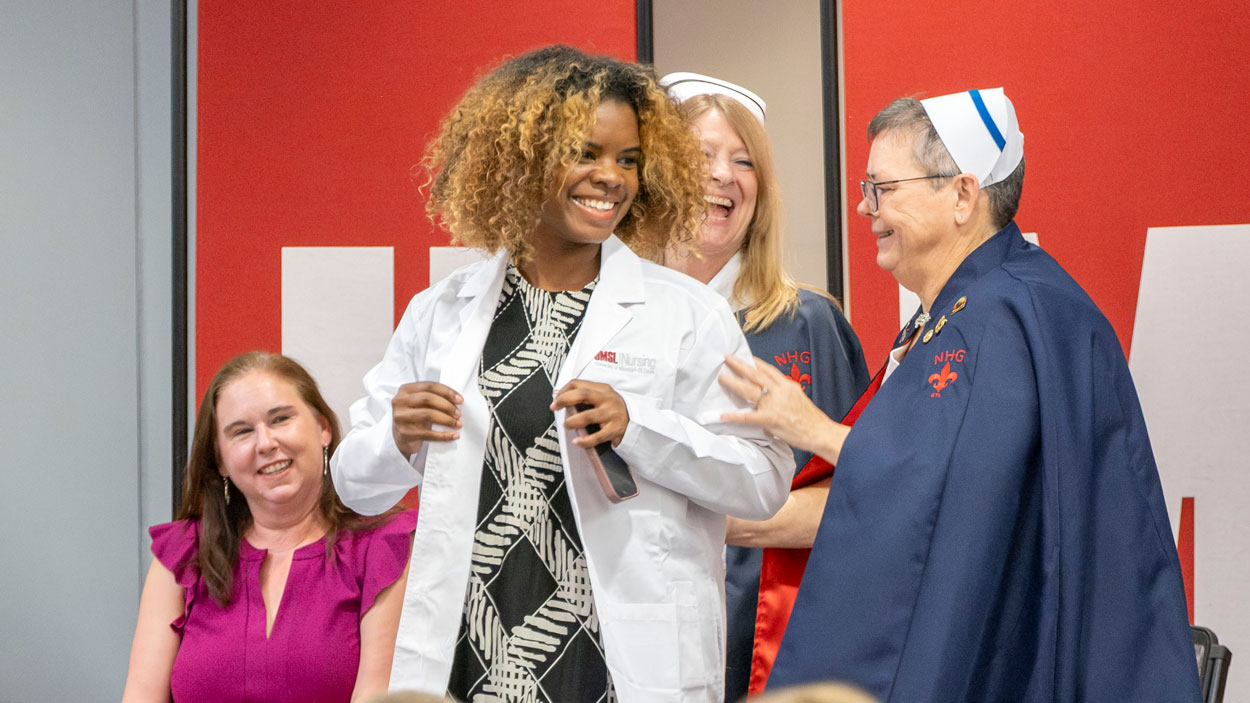 A nursing student recieves their white coat during the Lighting the Path Ceremony held in the MSC on Wedensday September 23, 2026. The ceremony presents nursing students with their white coat to symbolize their transition from the classroom to practice.