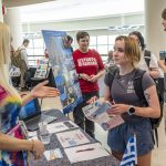 Jennifer Siciliani (at left), a teaching professor and director of undergraduate education in the Department of Psychological Sciences, talks with political science major Audrey Seger about a study abroad program she expects to lead next summer to Ikaria, Greece, during last Wednesday's Study Abroad Fair, hosted by UMSL Global.