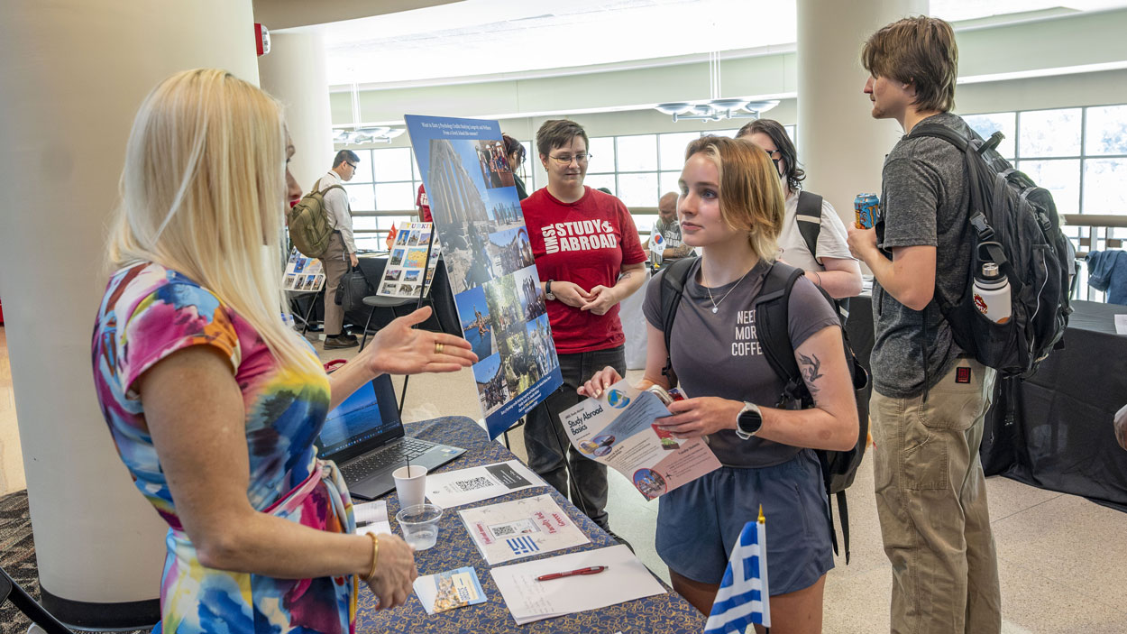 Jennifer Siciliani (at left), a teaching professor and director of undergraduate education in the Department of Psychological Sciences, talks with political science major Audrey Seger about a study abroad program she expects to lead next summer to Ikaria, Greece, during last Wednesday's Study Abroad Fair, hosted by UMSL Global.